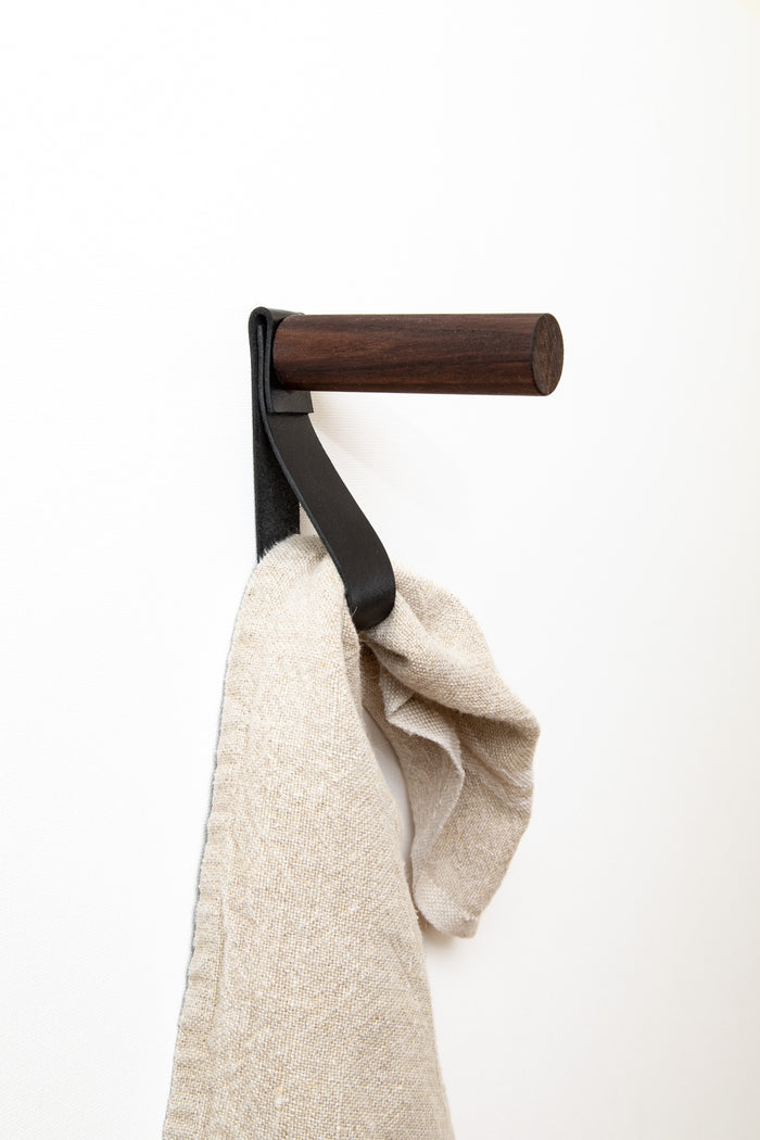 Keyaiira leather wall peg in walnut brown, styled with linen towel artisan-made home storage solution for contemporary spaces.